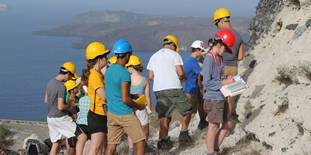 Students on fieldtrip on a cliff overlooking the sea, select to go to Courses and Programmes in the School of Earth Sciences.  